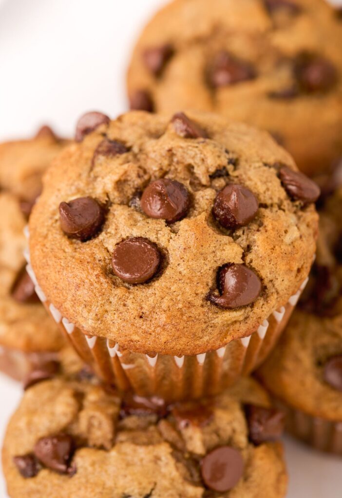 A close up picture of a muffin with chocolate on top. 