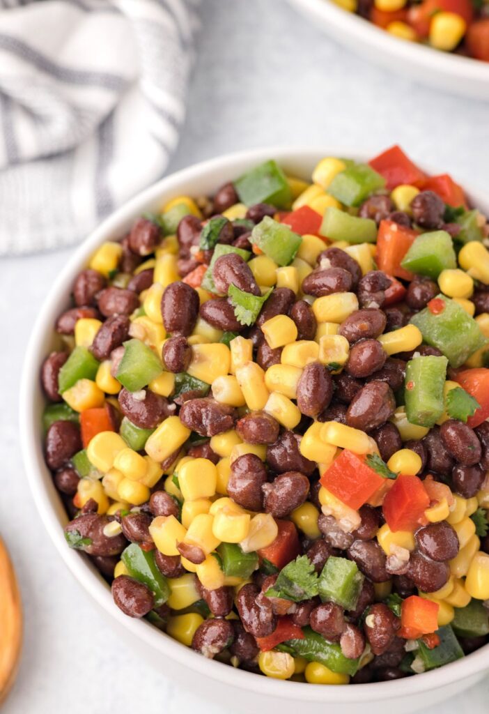 A serving dish of this salad with black beans, veggies, and corn. 
