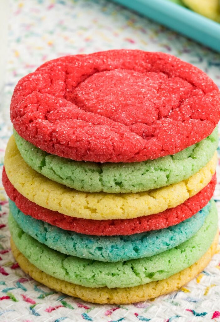 Stack of jello cookies with red on top and then green, yellow, and blue in the stack. 