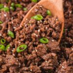 A skillet pan of this ground beef recipe up close on a wooden spoon.