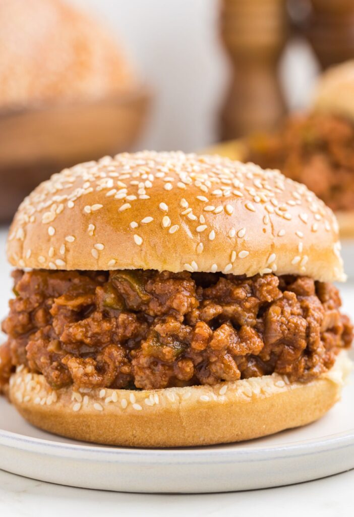 A sandwich with a hamburger bun and ground meat loose beef mixture. 