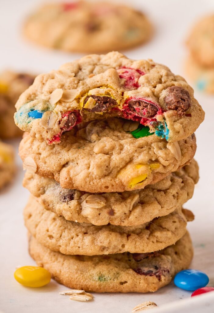 Stack of cookies with the top cookie having a bite taken out of it. 