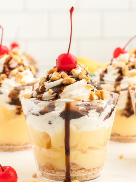 A dessert cup with layers of banana split.