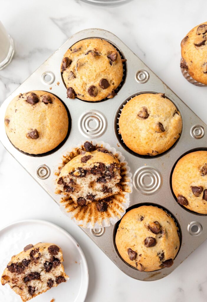 Overhead shot of the muffin pan and one muffin on a serving plate. 
