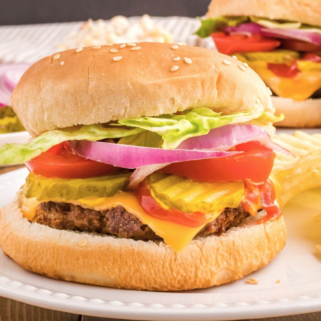 A Hamburger ready to serve inside a bun with toppings. 