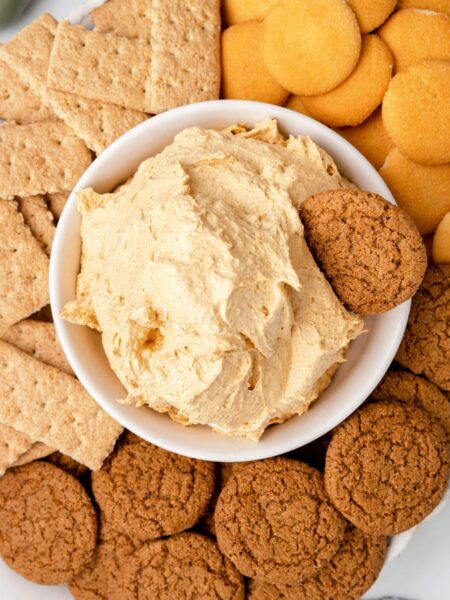 A serving platter of the fluff dip with cookies and crackers around it.