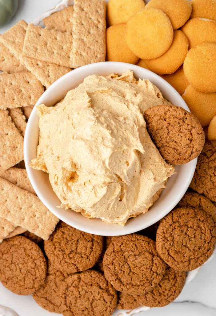 A serving platter of the fluff dip with cookies and crackers around it. 