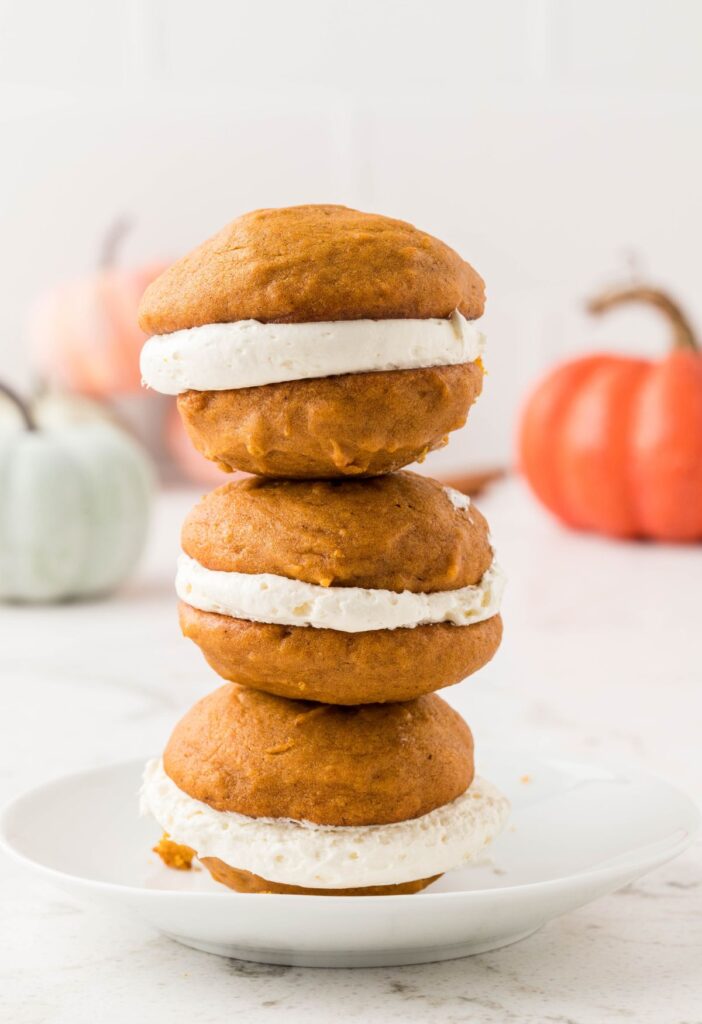 Stack of cookies sandwiches with cream cheese filling. 