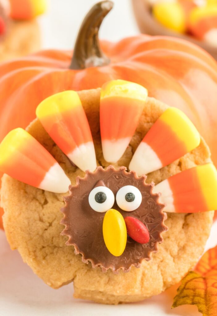 A cookie with candy that looks like a turkey head. 
