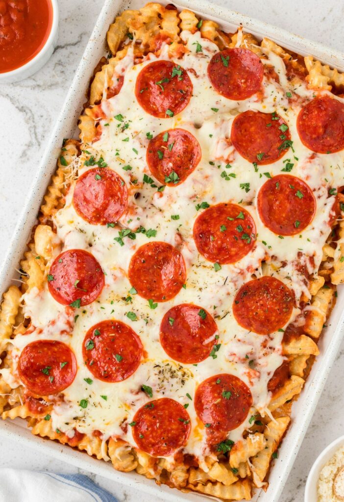 Overhead pic of the sheet pan of fries with pizza toppings. 