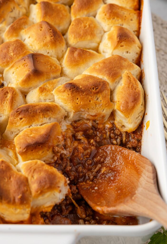 A casserole dish with the sloppy Joe casserole inside of it.